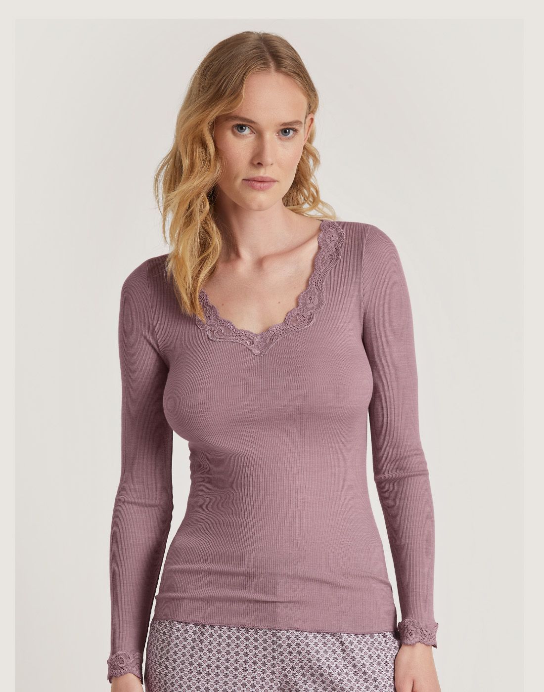 blond kvinne i ull og silke genser med blonde i rosa fra calida